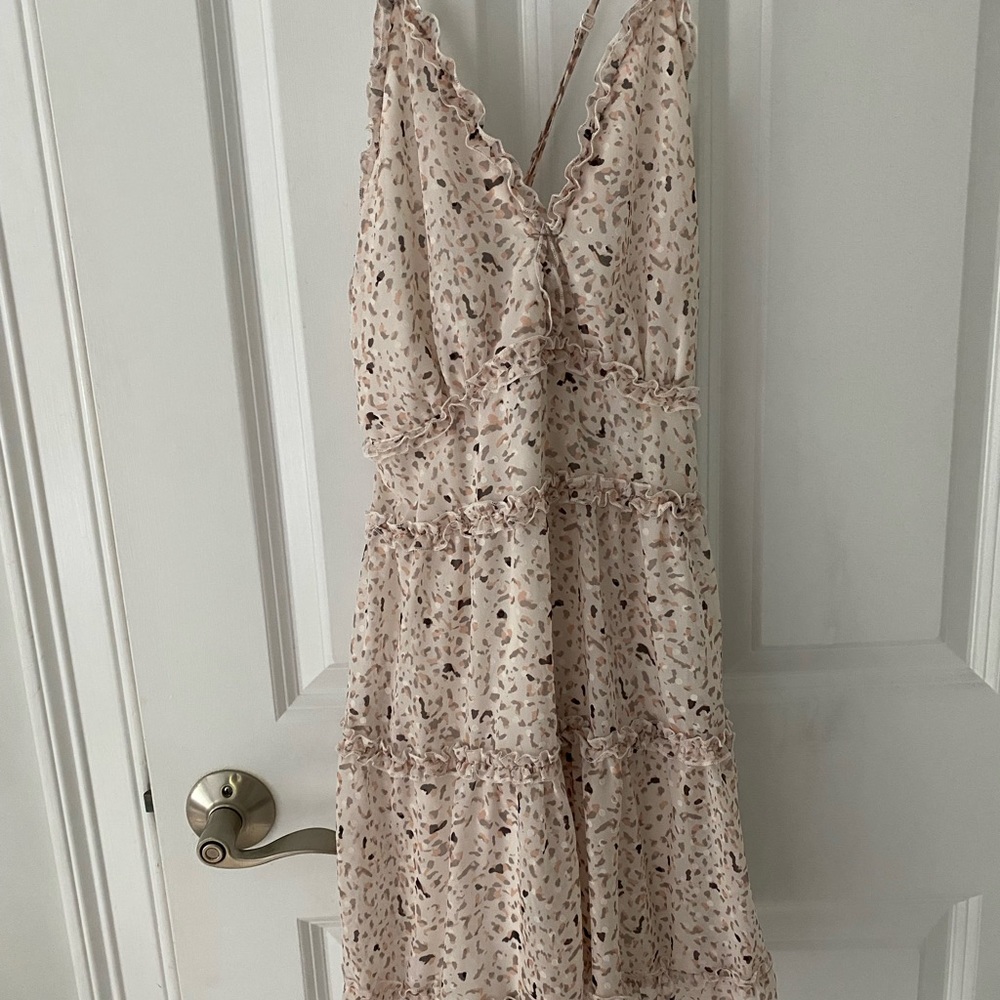 Brand new printed dress with cross strap detail in back